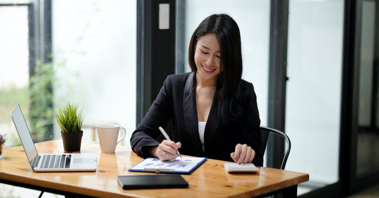 business-woman-accountant-working-with-computer-and-calculator-for-business-and-financial-expense